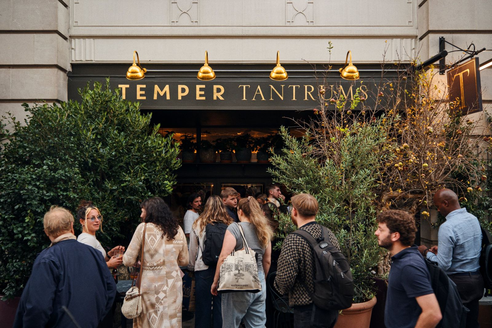 Guests gathered beneath the gold lettering of Temper Tantrums on Wimpole Street