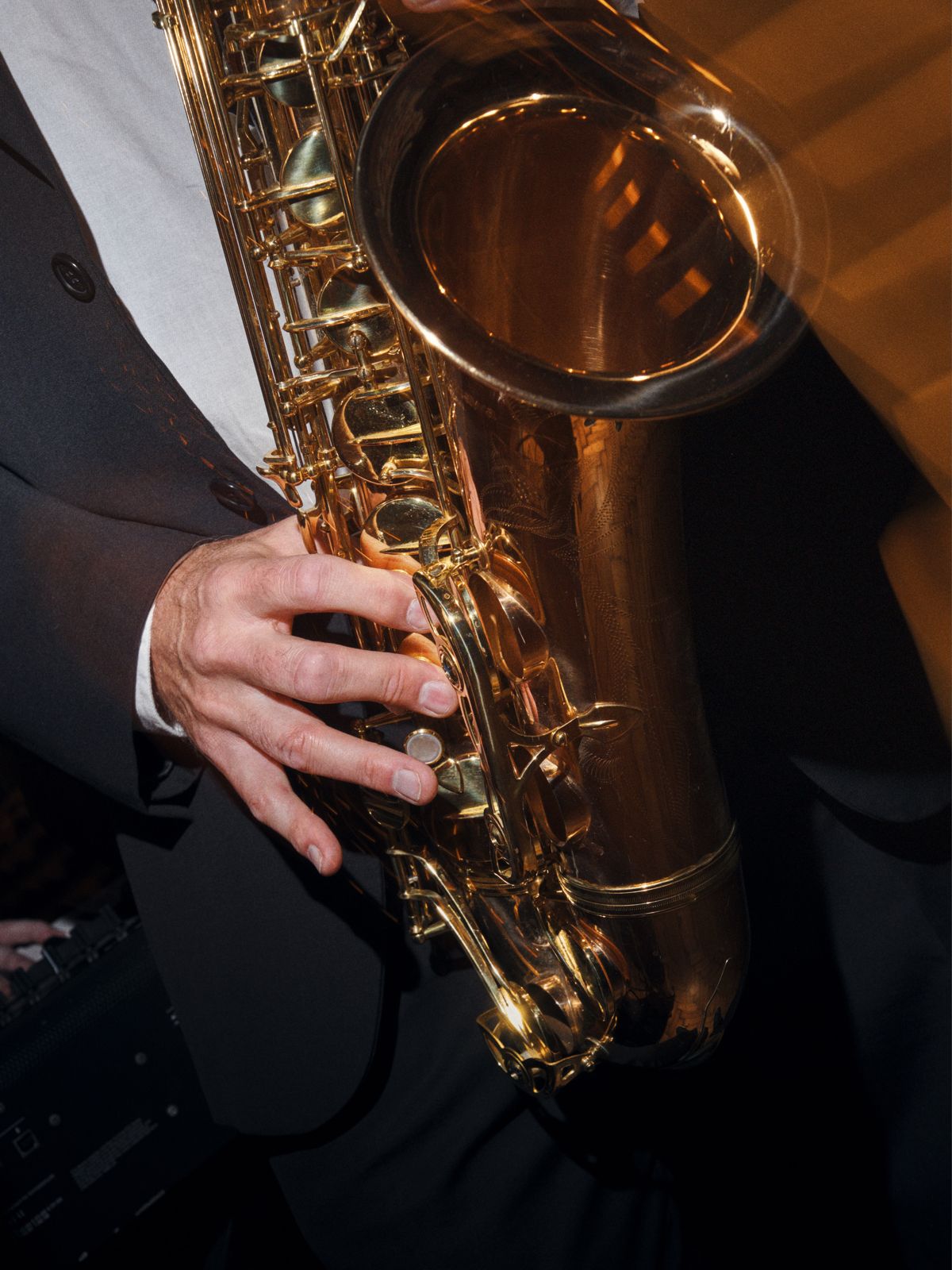 Saxophonist playing beneath the Bowie portrait